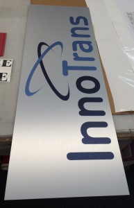 Brushed aluminum sign and color digital prints for small office