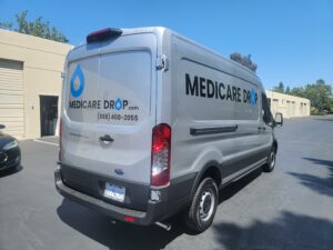 Gray commercial van with a Medicare Drop vehicle graphics