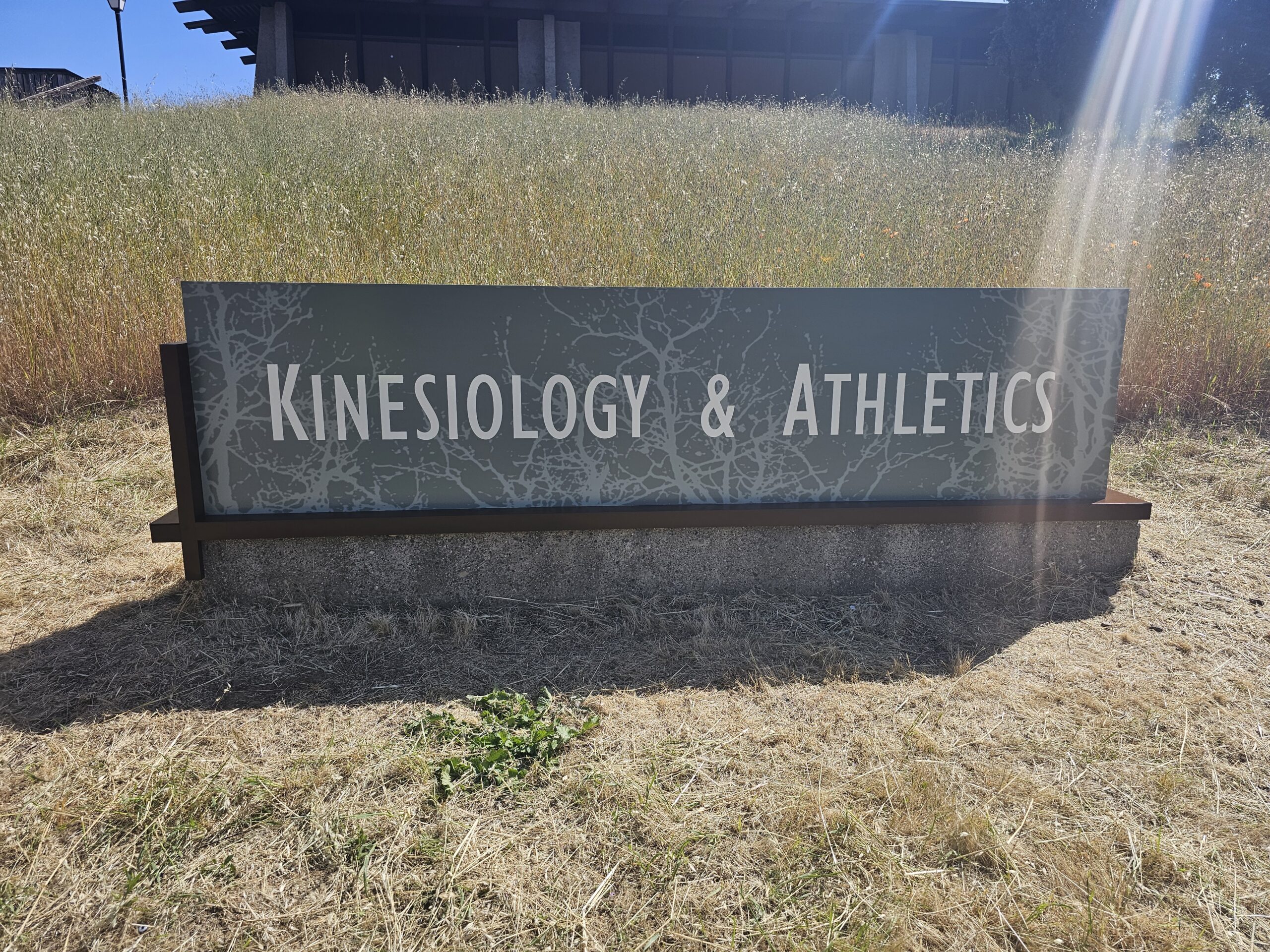 Kinesiology and Athletics monument sign in outdoor field